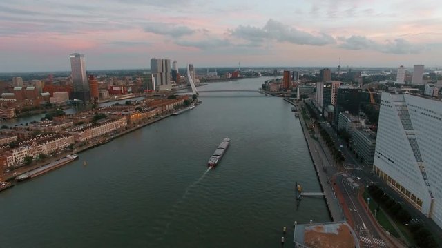 Aerial shot of Rotterdam city with view to the river, Erasmus Bridge and waterside buildings