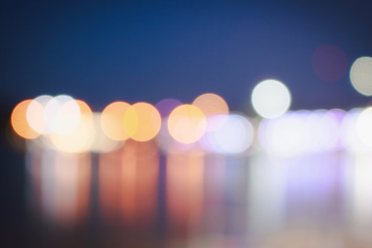 Abstract blurred bokeh at twilight time with reflection on river