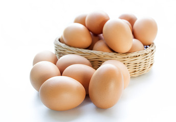 Eggs in basket isolated on white background