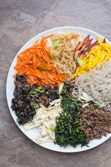 Japchae0 Korean sweet potato noodles with various vegetables, meat and eggs