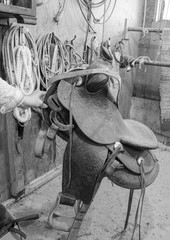 vintage western saddle hung by rope