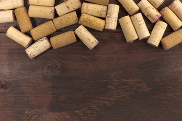 Wine corks on dark wooden texture with copyspace