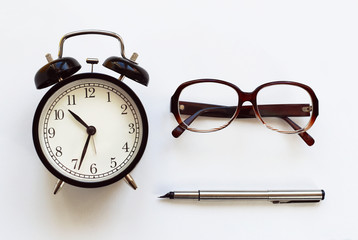classic table clock pen, glasses on a white background. interior Features