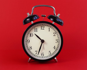 classic table clock on a red background. interior Features