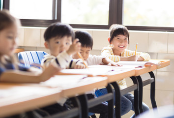 happy little girl student  in the classroom