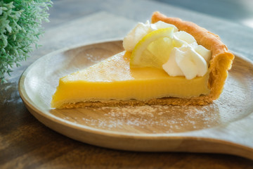 Lemon tart on wooden plate