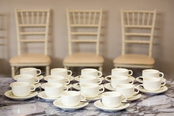 Coffee mugs on a table at a party.