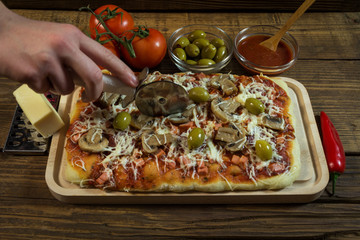 Cutting a pizza on a wooden board