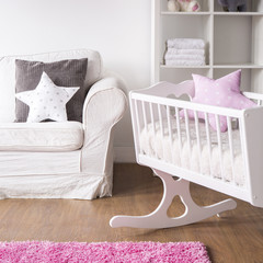 Bright nursery room with cradle