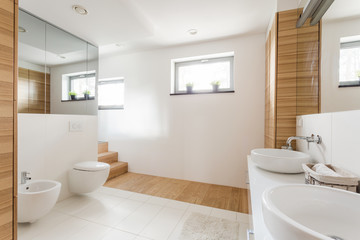 Naklejka na ściany i meble Bathroom with toilet and wide mirrors