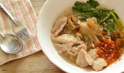 stir fried large noodle with  marinated pork in gravy sauce on bowl