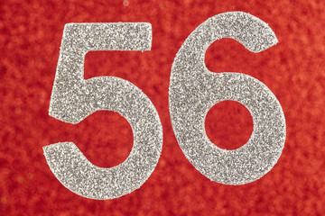 Number fifty-six silver color over a red background. Anniversary