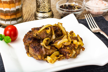 Fried beef liver with onions, curry and spices