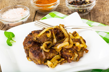Fried beef liver with onions, curry and spices