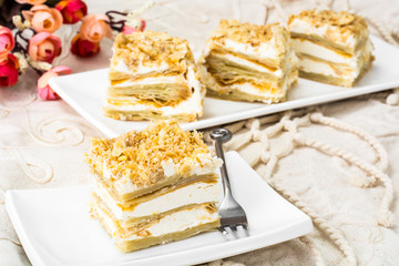 Portion cake of puff pastry with vanilla butter cream