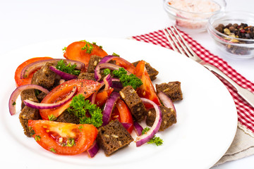 Simple salad with bread, tomato, red onion, vegetable oi