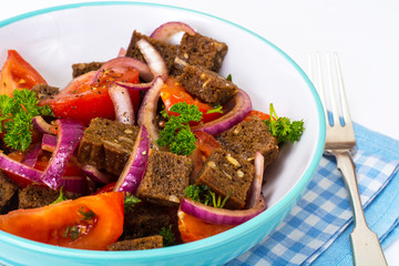 Simple salad with bread, tomato, red onion, vegetable oi