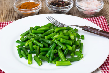 Salad of green beans on white plate