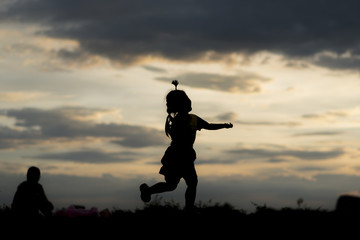 silhouette A kid run at sunset