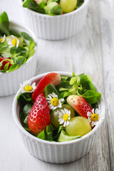 Salad with lamb's lettuce (Valerianella locusta), strawberries,