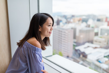 Woman looking though the view of city inside lookout