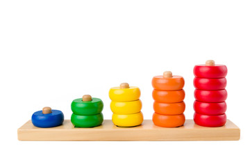 Colorful wooden children toy scores from one to five figures of the colored rings isolated on a white background. Studio shot.