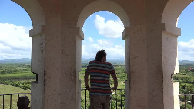 Guy examining the Sugar Mills Valley from the top of the Manaca Iznaga Tower (slaves supervision tower). Cuba