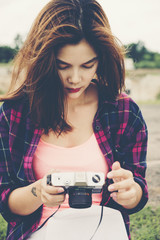 Woman standing holding a camera,Traveling Holiday Photography Concept.