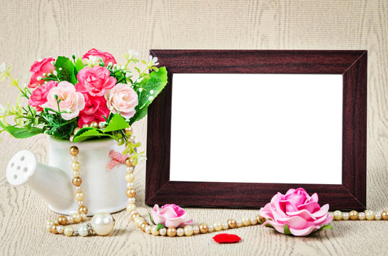 Empty old wooden photho frame with roses.