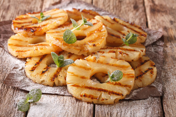 Homemade grilled pineapple on the paper close-up. Horizontal