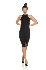 young woman in tighit black dress on white background