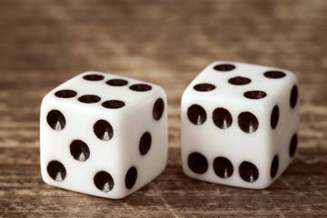 Two dice on dark wooden table