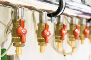 A lot of ball valves, arranged in a row.