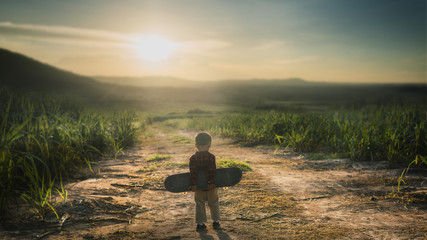 Little child Holding Skateboard