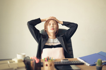 Portrait of asian business woman in the office and having headache, overwork and stress concept.