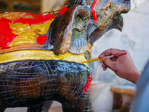 Hand of artist painting asia elephant