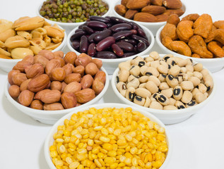 Almond, Cashew nuts, yellow bean, green bean, rice, fettucine, all put on small white cup and on white background