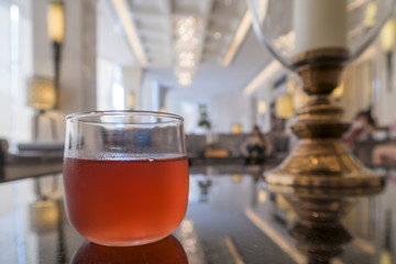 Cranberry cocktail in a hotel lobby, shallow DOF