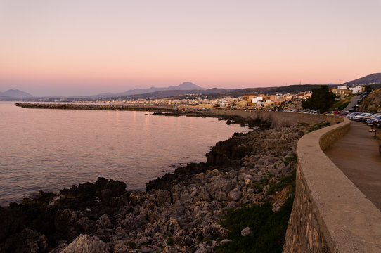 Promenade along the coast and below Fortezza fortress at twilight, city of Rethymno, Crete, Greece