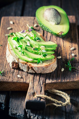Wholegrain bread with avocado and herbs for spring breakfast