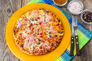 Homemade pizza with ham and mushrooms