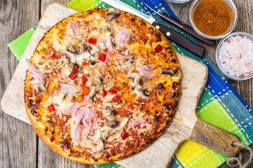 Homemade pizza with ham and mushrooms