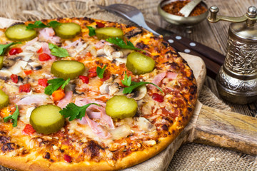 Homemade pizza with ham and mushrooms