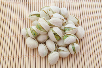 Pistachio nuts on bamboo background