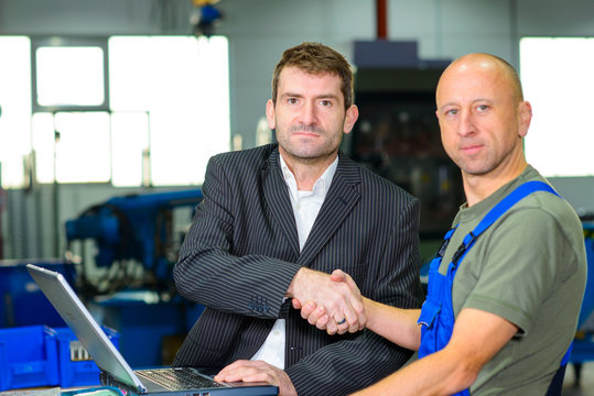 boss and worker on work bench