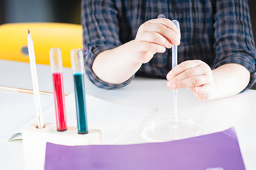 Caucasian child spends chemical experiences in class room