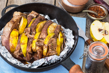 Meat with quince baking in foil in the oven