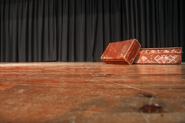 Theatre Stage. On the stage there are two old suitcases.