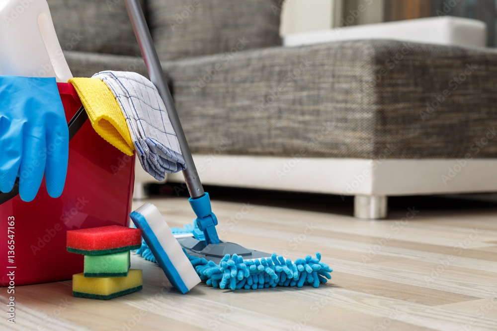 Wall mural cleaning service. bucket with sponges, chemicals bottles and mopping stick. rubber gloves and towel.