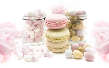 Easter Treats with mini eggs pink roses and Marshmallows on a wh